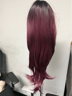 The wig features a deep purple gradient design, showcasing rich layering and a stylish color palette.