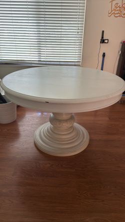 White wooden dining table w/ extendable sleeve