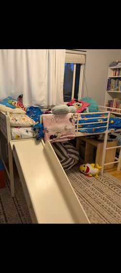 Raised twin bed with slide