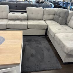 Light gray micro fiber sectional with drop down  cupholder