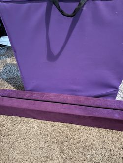 Balance beam and gymnastics mat