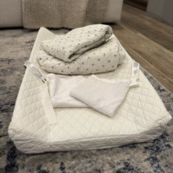 Changing pad with 2 Land of Nod fitted sheets