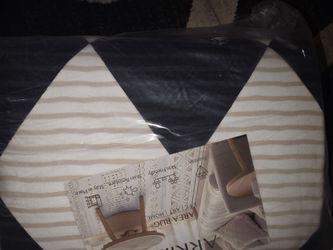 Black and beige area rug, brand new in plastic