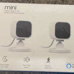 2 White Blink Mini Indoor Cameras With Stands, Mounting Screws, Power Adapters/usb Cables