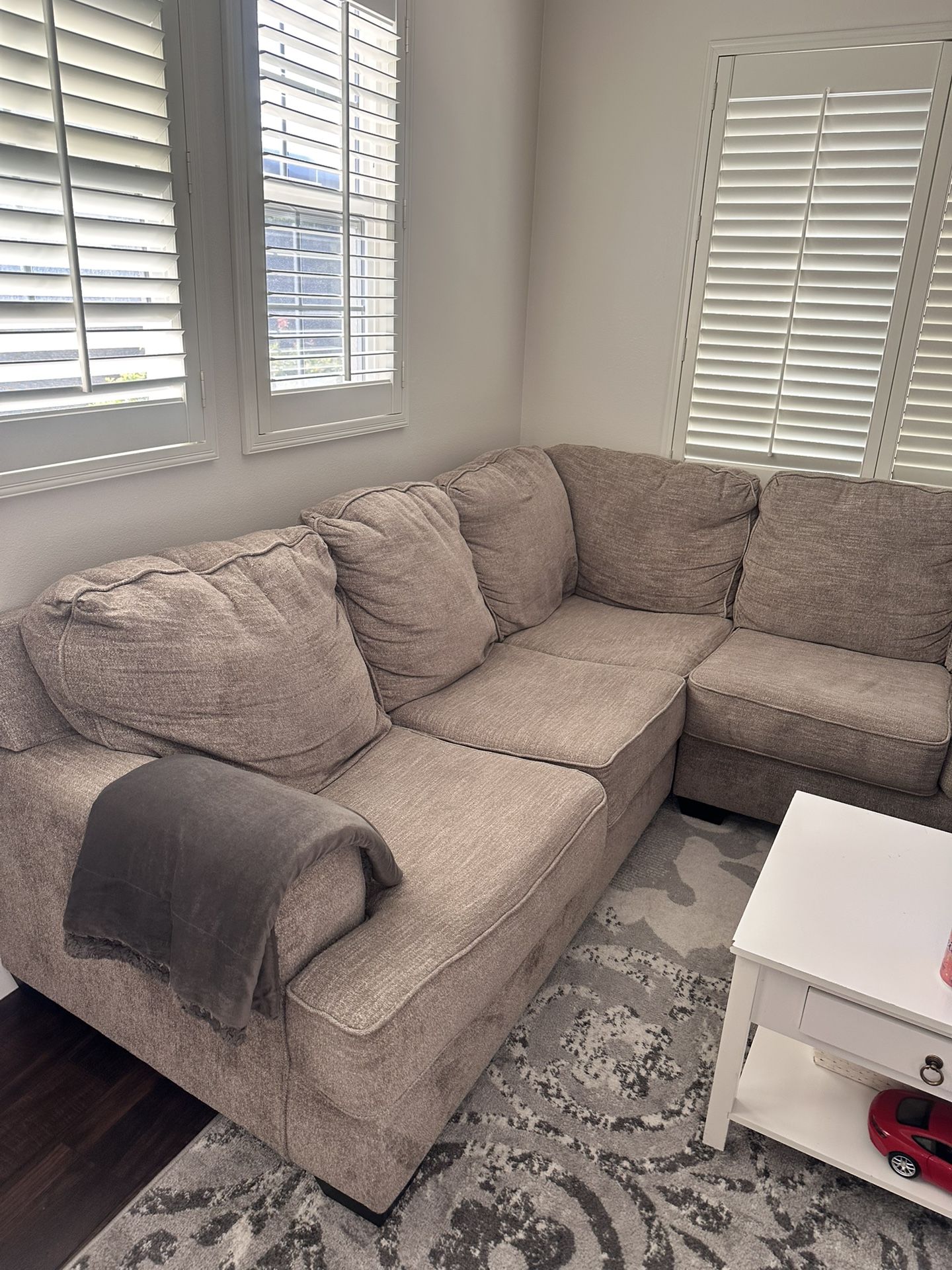 Gray 2 Piece Sectional Couch- No Too Much Wear. Does Not Have Pull Out Bed. 100 Inches On The Long Side , 90 On The “L” Portion.