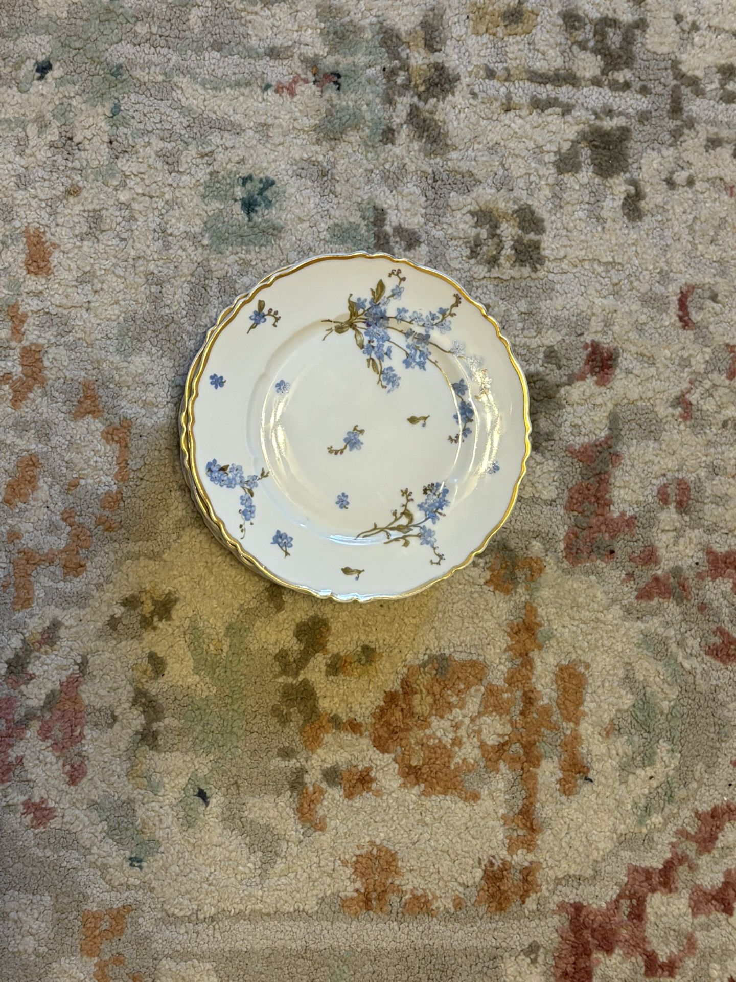 Stunning set of 10 Haviland Limoges Montmery cake/dessert plates, crafted in France. Features delicate blue floral design with gold trim and scalloped