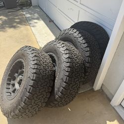 4 BF Goodrich KO2 All-Terrain tires (285/70R17) mounted on Pro Comp Bandido flat black wheels