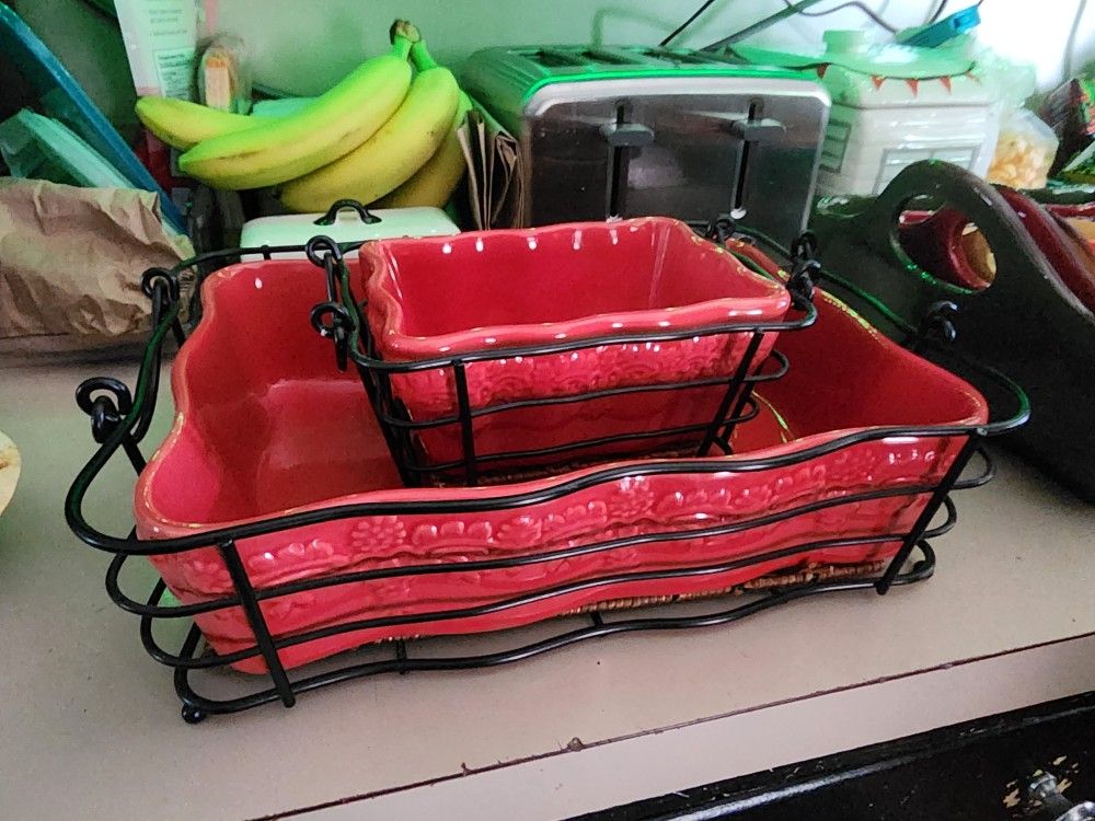Pair of red stoneware Casserol dishes with metal and Wicker baskets