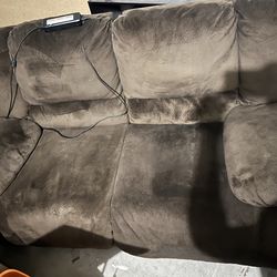 Brown electric reclining love seat.