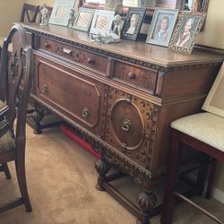 Antique buffet table with six chairs in China cabinet over 120 years old