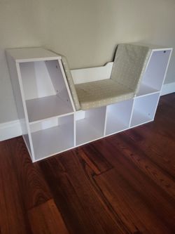 Bookcase reading nook with cushion