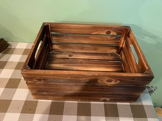Solid wood slatted storage crate 13 by 9.5 inches, 6 inches tall, has hanging hardware on rear for wall storage. Has handle areas on each side, finish