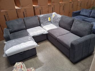Dark gray sectional sofa with pull-out bed and ottoman storage