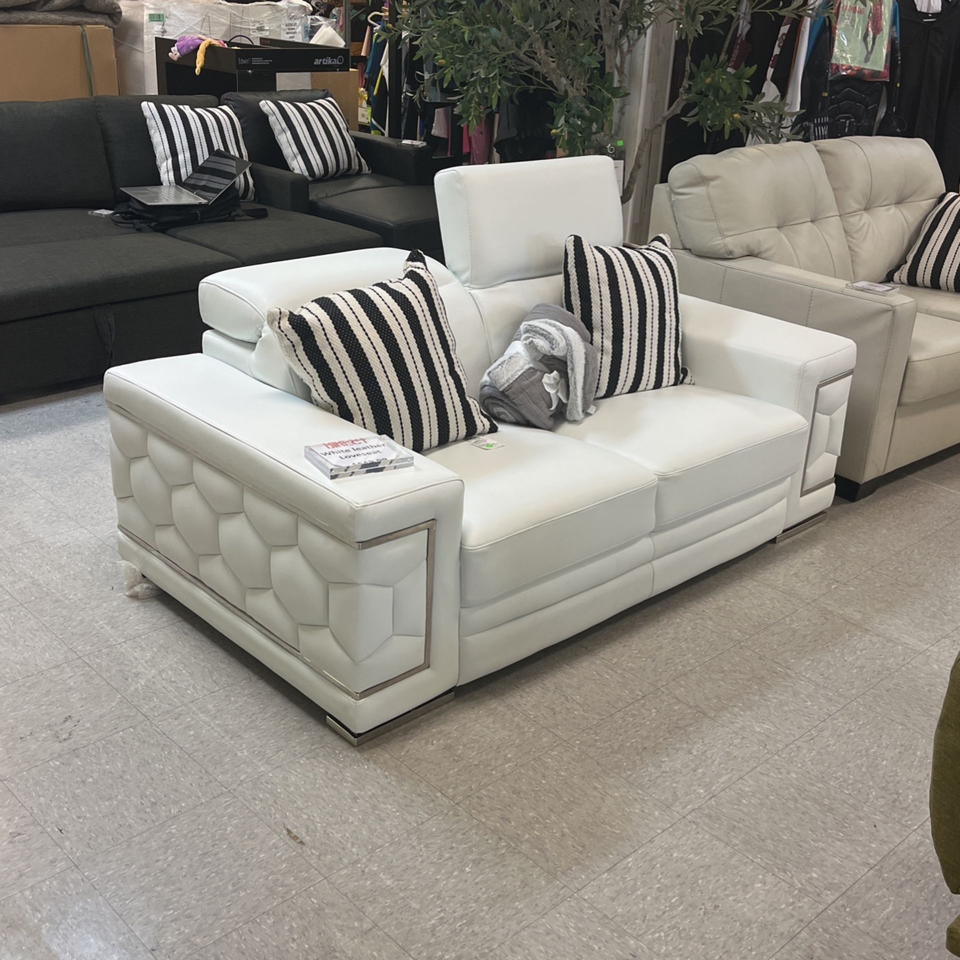 White Leather Loveseat With Adjustable Head Rests.