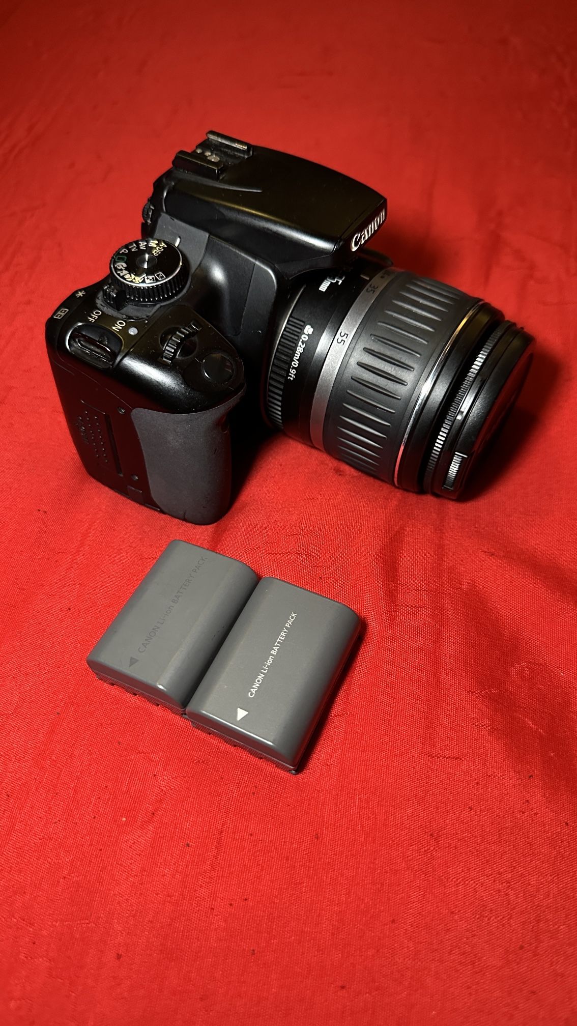 Canon EOS Digital Rebel XTi 10.1 Megapixel SLR Black Camera Body E with Canon EF-S Zoom 18-55mm 0.28 m/0.9 Ft, 1:3 . 5-5.6 58mm Camera Lens 3 Battery
