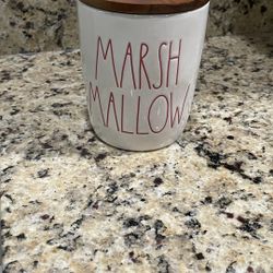  Rae Dunn "Marshmallow" ceramic cellar canister with a wooden lid and red lettering. 