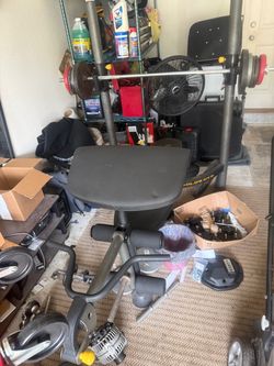 Golds gym bench, curl bars, with over 250 pound of weights.