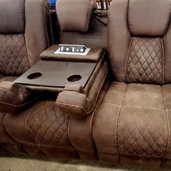 Beautiful, elegant luxury, Italian leather double recliner sofa with pull down the center, and USB ports with electric connections and lightt overhead