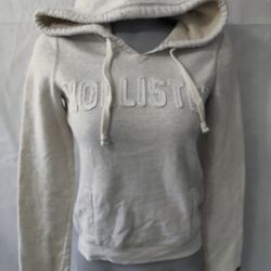 cream-colored Hollister hoodie featuring the brand's logo applied on the chest and a red embroidered seagull logo on the sleeve.  Excellent condition 