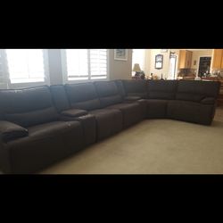 8 piece brown brushed suede couch with 4 recliners.
