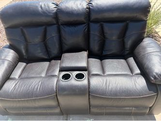 Dual reclining loveseat with center console and cup holders.