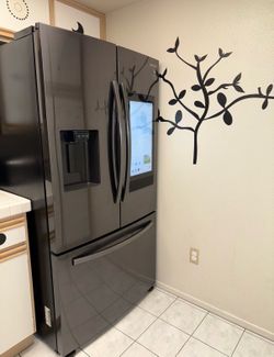 Samsung Black stainless steel refrigerator, stove and microwave set