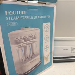 Hauture Steam Sterilizer & Dryer . Perfect for keeping baby bottles and pump parts clean and ready to use.