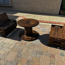 Rustic Benches Made From Wooden Pallets And Table Made From Wooden Spool.