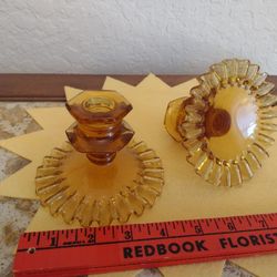 Set of two vintage amber glass candle holders.  One has small chip on bottom of top rim as shown in picture, not visible when displayed.  Possibly Fen