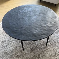 Crate and Barrel round black iron coffee table $150