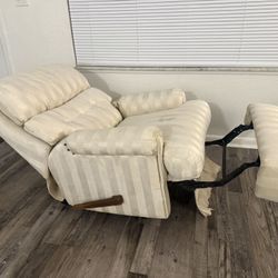 Cream-colored fabric upholstered recliner chair with a vertical striped pattern. 