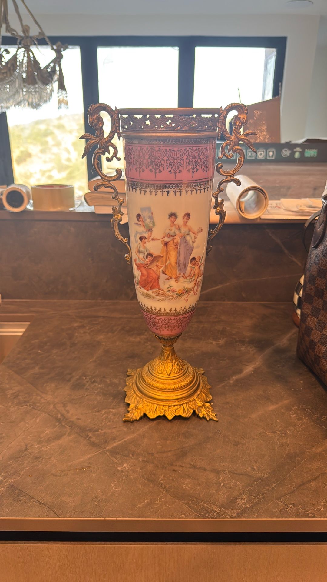 Limoges porcelain vase ,likely from the early 20th century, characterized by its hand-painted decoration and gilt bronze h