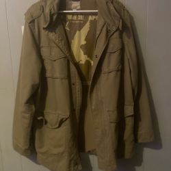 olive-green military-style utility jacket with a large winged horse graphic and star symbol
