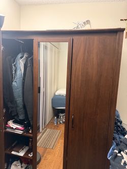 Brown dresser with 3 doors and mirror