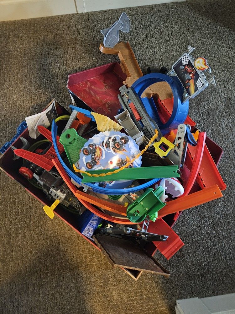 Box of assorted Hot Wheels track pieces and accessories