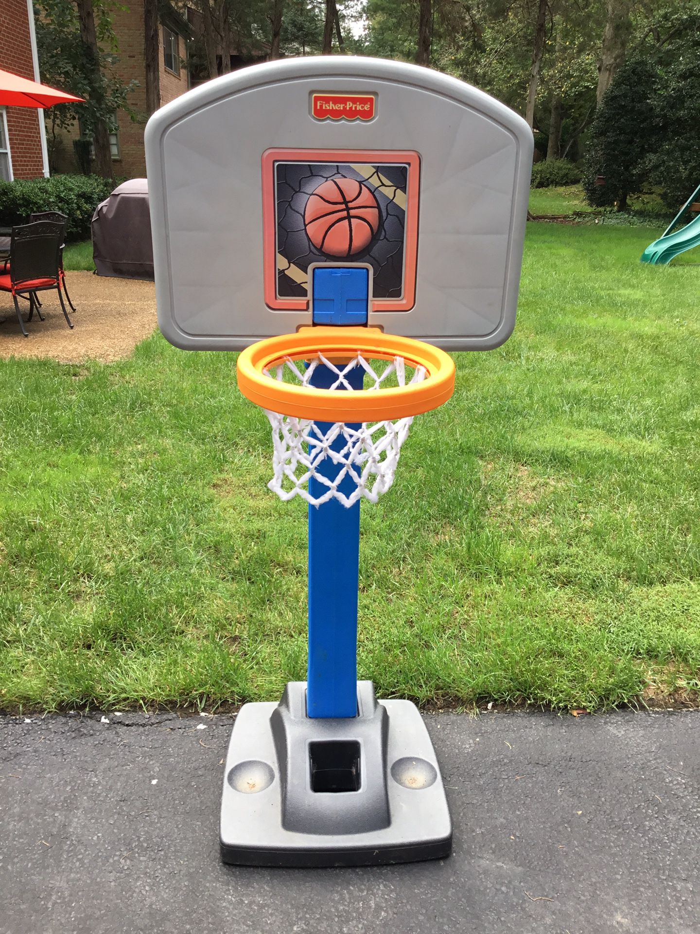 Children’s outdoor Fisher Price adjustable basketball net.