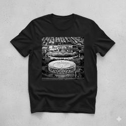 This T-shirt features a black and white aerial view of the Oakland Coliseum and the adjacent Oakland Arena.
​These venues, officially part of the Oakl
