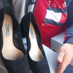 This is a pair of black suede Prada block heel pumps. 