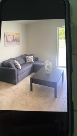 Grey sofa bed with table and tv table