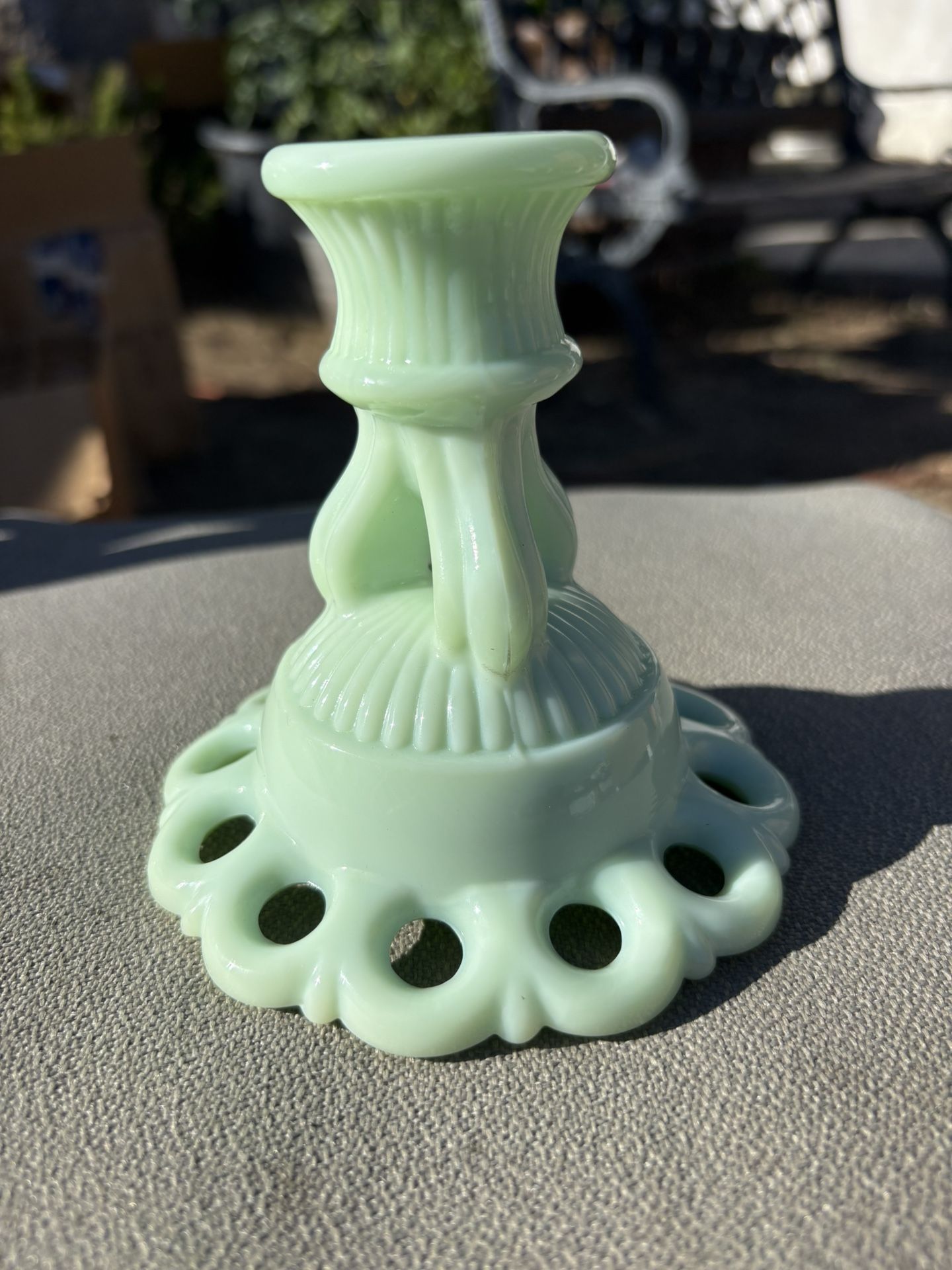 This is a vintage Westmoreland "Doric Open Lace" candlestick in green satin milk glass.