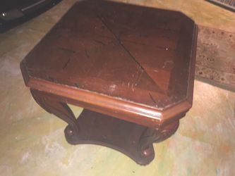 End table with carved legs and a shelf