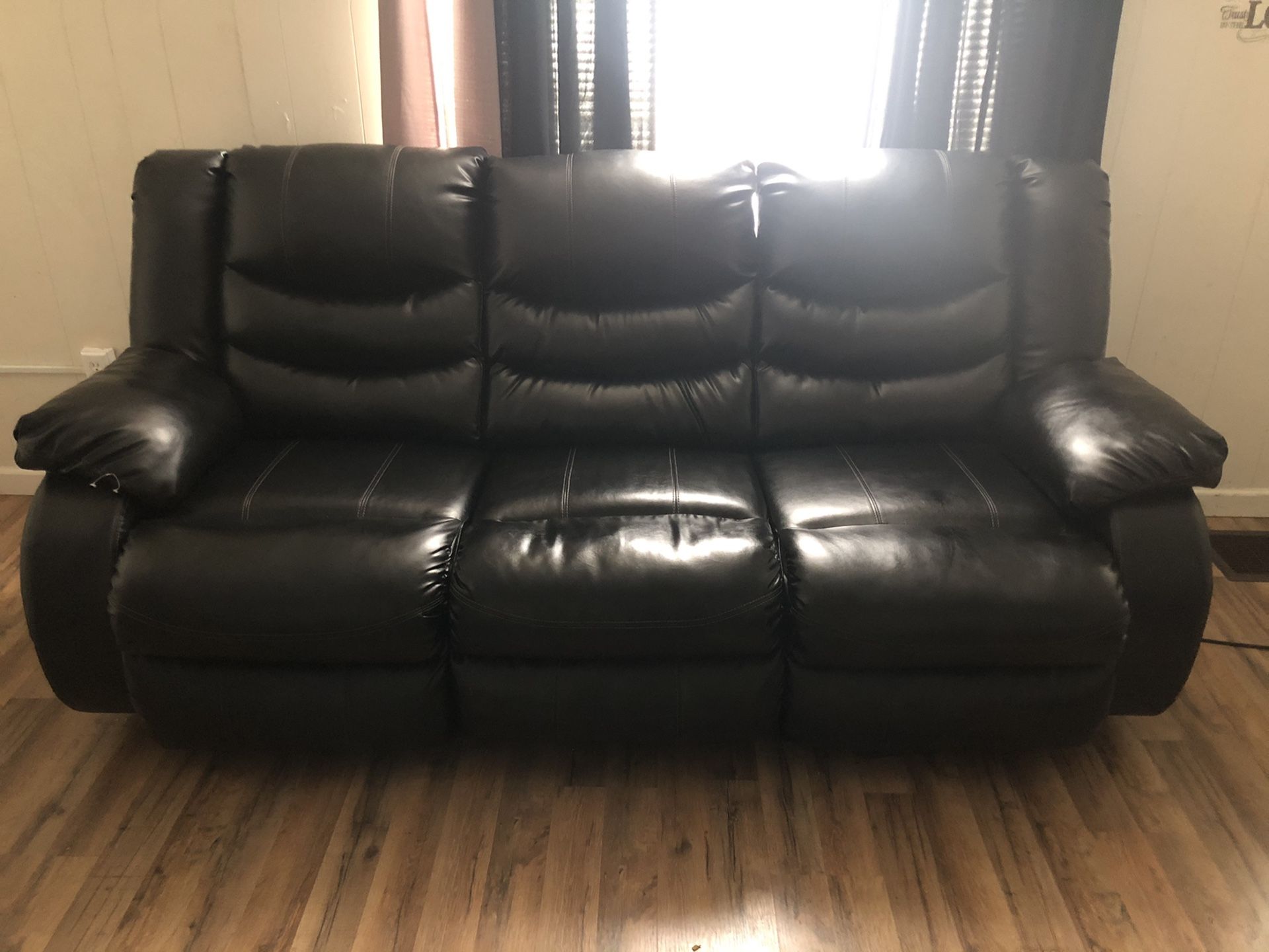 Black leather recliner sofa