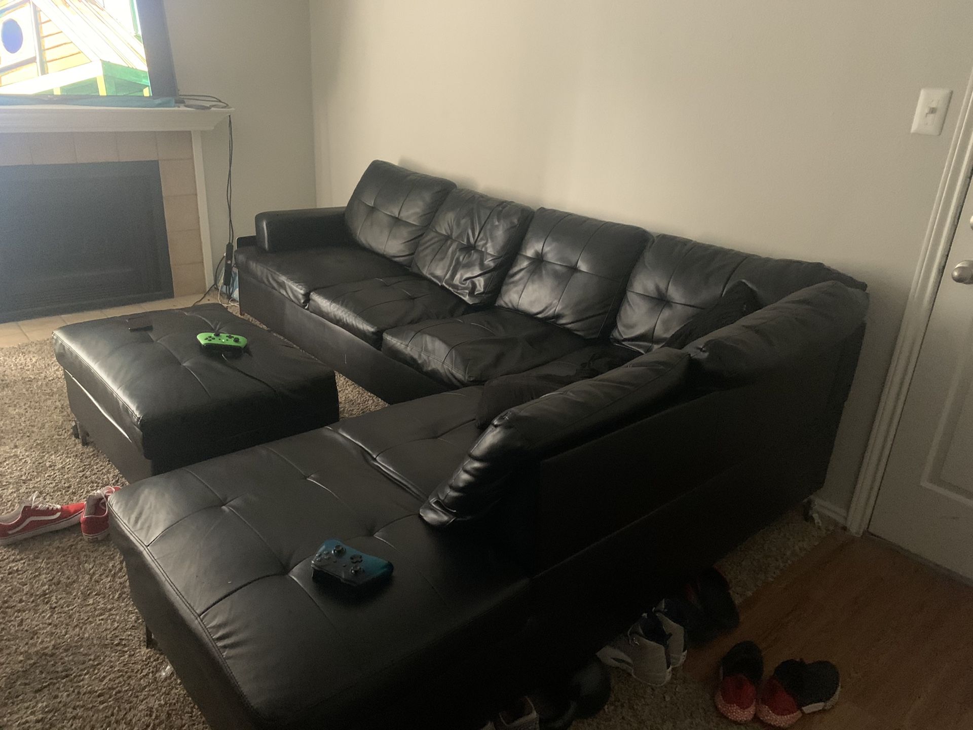Black leather sectional and otto man