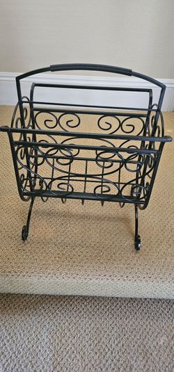 Metal magazine rack with decorative swirl design