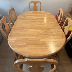  wood oval table with 6 chairs and table cover . 