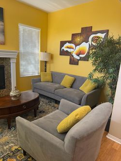 Gray Upholstered Sofa with Yellow Throw Pillows