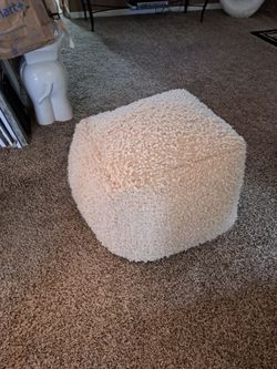 Cream fuzzy ottoman