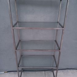 gray metal shelving with glass base in good condition 