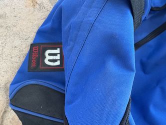 Blue Wilson duffel bag with rollers.