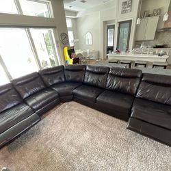 Five piece leather sectional with queen size sleeper and to end motorized recliners